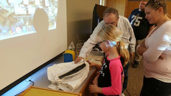 Beekeeper explaining his equipment.