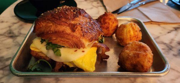 Everything croissant with egg and bacon. The hash browns balls are just amazing, with melted cheese inside.