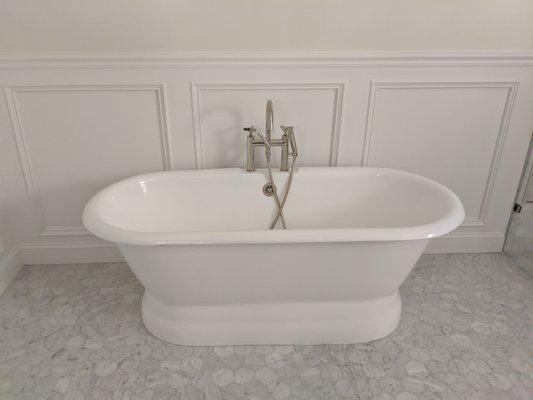 Cast iron free standing tub with polished nickel faucet.