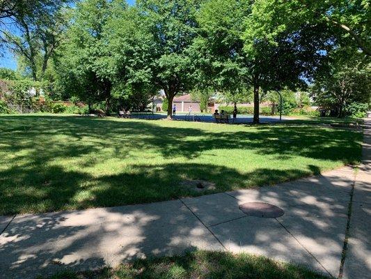 Grassy area and full basketball court.