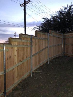 6' board on board fence with 2x6 top cap, stepped per grade (hoa required fencing)