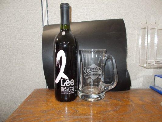 Full wine bottle etched and color filled in 2 colors. Mug has cheers logo