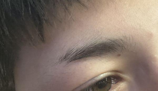 Right eyebrow half shaved off.