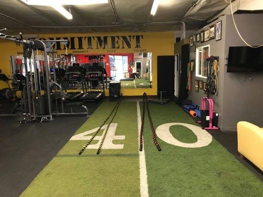 An indoor turf for sledge push and a back parking lot for tire throw downs.