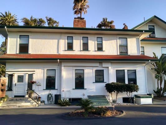 Gutters were installed to both top and bottom levels, with 2 spouts and rain barrels added. They did this old house proud!