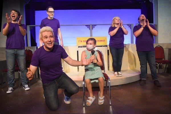 Rockin' Awesome cast member, Jeremy, improvsing with an audience volunteer!