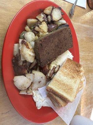 Two eggs over medium, potatoes with peppers and onions, scrapple and toast