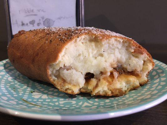 The potato knish with caramelized onions and cheese.