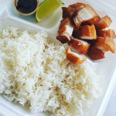 Pork belly with white rice and side of spicy soy sauce and lime