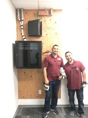 Hector and Mark proudly standing next to an awesome installation in our tech room!