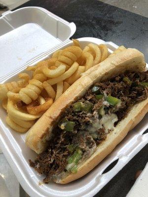 Philly cheesesteak and curly fries w/ season salt.