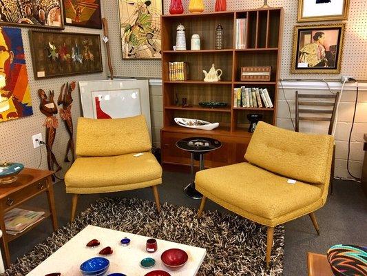 Pair of mid century scoop chairs with original upholstery staged with a domino mobler teak bookcase