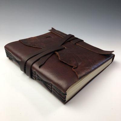 Touch the Sky Books - Hand bound Leather Journals and Accessories. Tin Jewelry