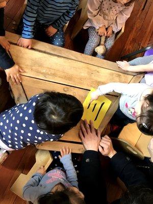 Our youngest students learning to trace Chinese characters written in sand paper with their fingers