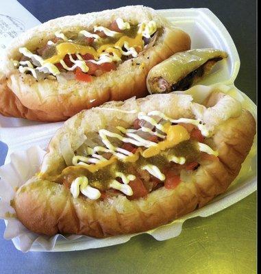 Hot dogs- buttery toasted bun with bacon wrapped hotdog with green chili topped with onion, tomato, mustard, and mayo.