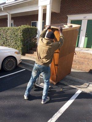 Moving a dresser.