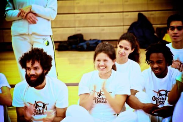 Singing while watching the Capoeira game.