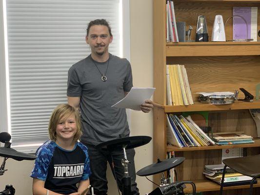 Cam teaching a drum lesson