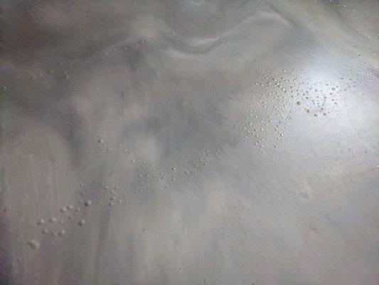 Epoxy coating, metallic matte with excessive blistering/bubbles due to incorrect prep of the concrete