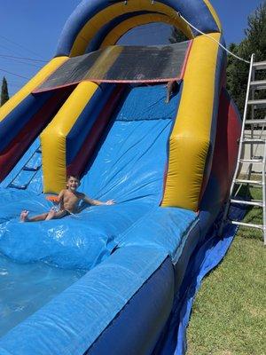 My son at his birthday party loving the water slide.