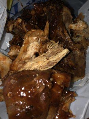 Old chicken smothered in barbecue sauce in trash bag.