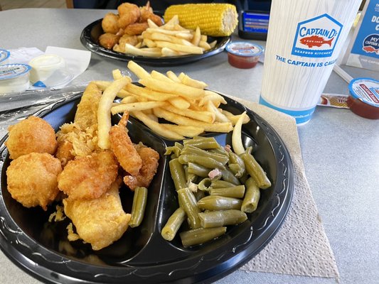 Fish and shrimp senior meal with green beans and French fries.