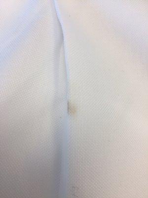 Burn mark on brand new shirt from their press.  Looks almost like a cigarette burn.