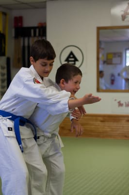 Elbow strike into Bear Hug from the Rear arms pinned.