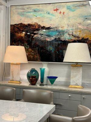 Alberto Sanchez mixed artwork, Italian credenza with marble top, and stunning crescent table lamps by Michael S. Smith from Visual Comfort.