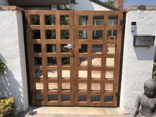 These steel frame and wood overlay gates are equipped with an electronic strike and WiFi audio and video entry.