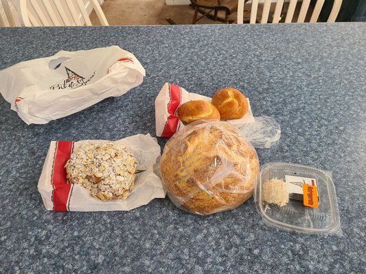 Almond croissant, sourdough, two challah knots, and two cake balls