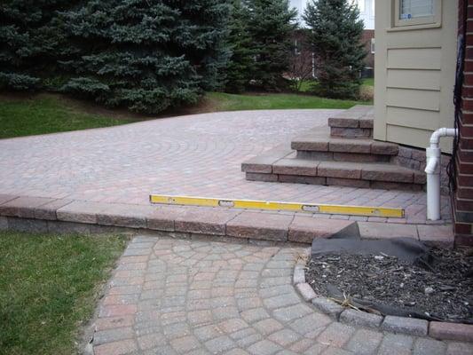 Paver sidewalk transitions into brick paver patio for great entertainment