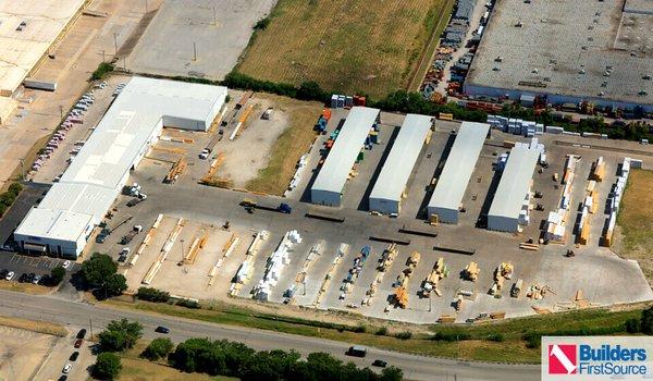 Building materials supplier Builders FirstSource's forklift is moving wood roof trusses.