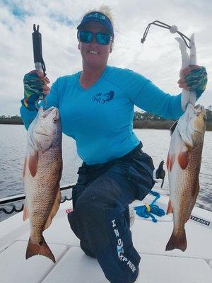 Captain Bobbi with 2 nice redfish.