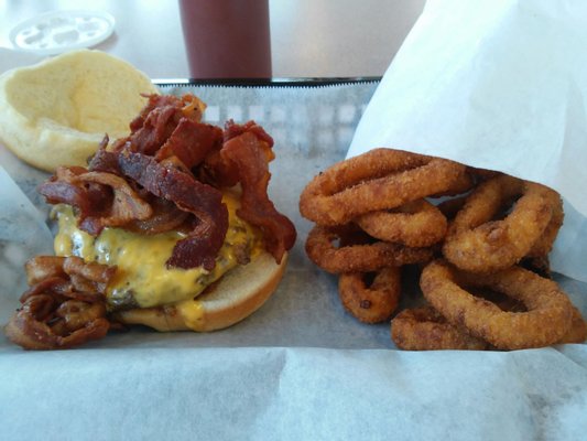 Big, juicy, delicious bacon burger and onion rings!