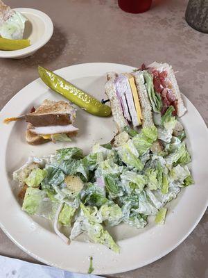 Half Caesar salad and half club sandwich