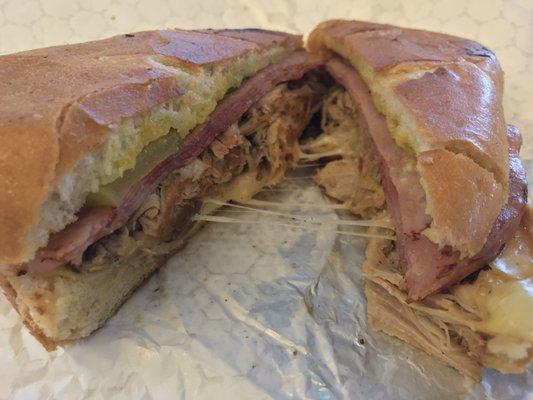 Cubano. It was the juiciest freaken pork ever inside! It was unreal and look at the cheese pull. Only wish for the bread to be crispier.