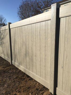 6-foot high Lakeland vinyl privacy fence, Adobe finish, streaked and embossed for a wood-like look