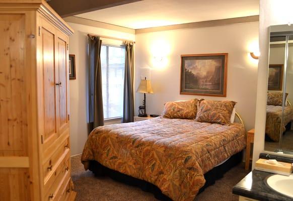 Queen Sized Bed, TV and Vanity in Bedroom