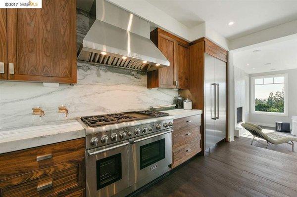 Kitchen: Full overlay, frameless Walnut Cabinetry with a clear conversion varnish "satin" sheen finish.