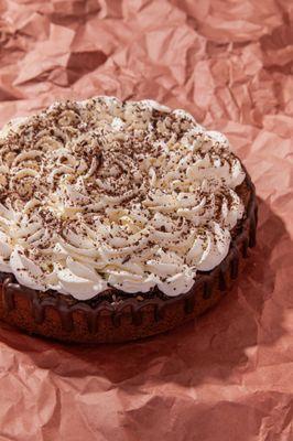 Gourmet deep-dish Brownie Cake topped with homemade whipped cream & chocolate shavings