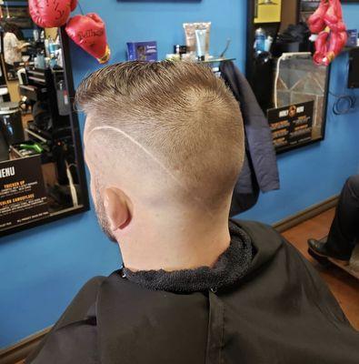 Bald fade haircut with line design