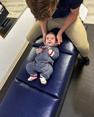 Infant getting his neck adjusted