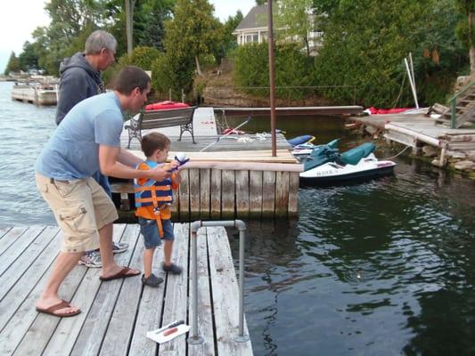 Teaching my grandson how to fish (he remembers his uncle catching a muskie off this dock!)