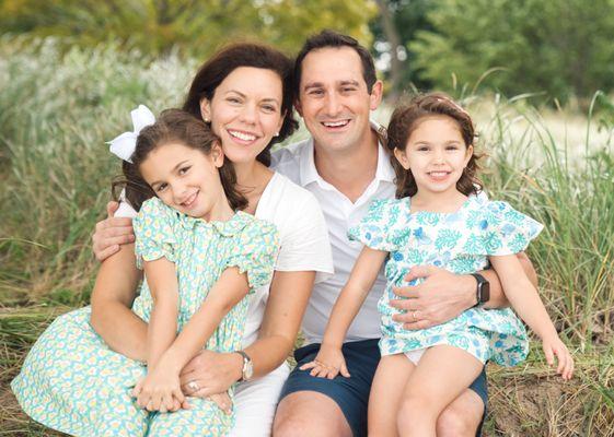 A family at the beach in grasses