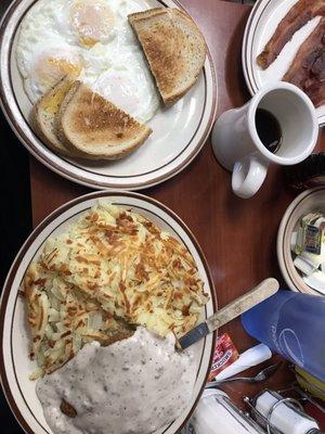 Country fried steak and eggs with hashbrowns and ye toast.