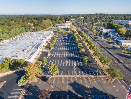 Aerial view of a parking lot that has fresh asphalt and line striping.