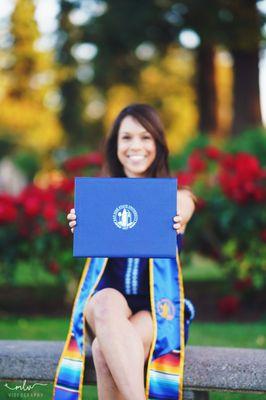 San Jose State University graduate holding her well deserved diploma loud and proud!