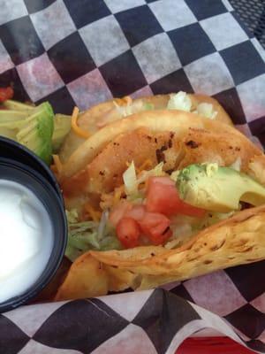 Deep fried beef tacos with avocado.