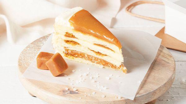 Light, buttery vanilla-flecked cake has waves of caramel cake and layered with salted caramel crunch and a creamy custard layer.